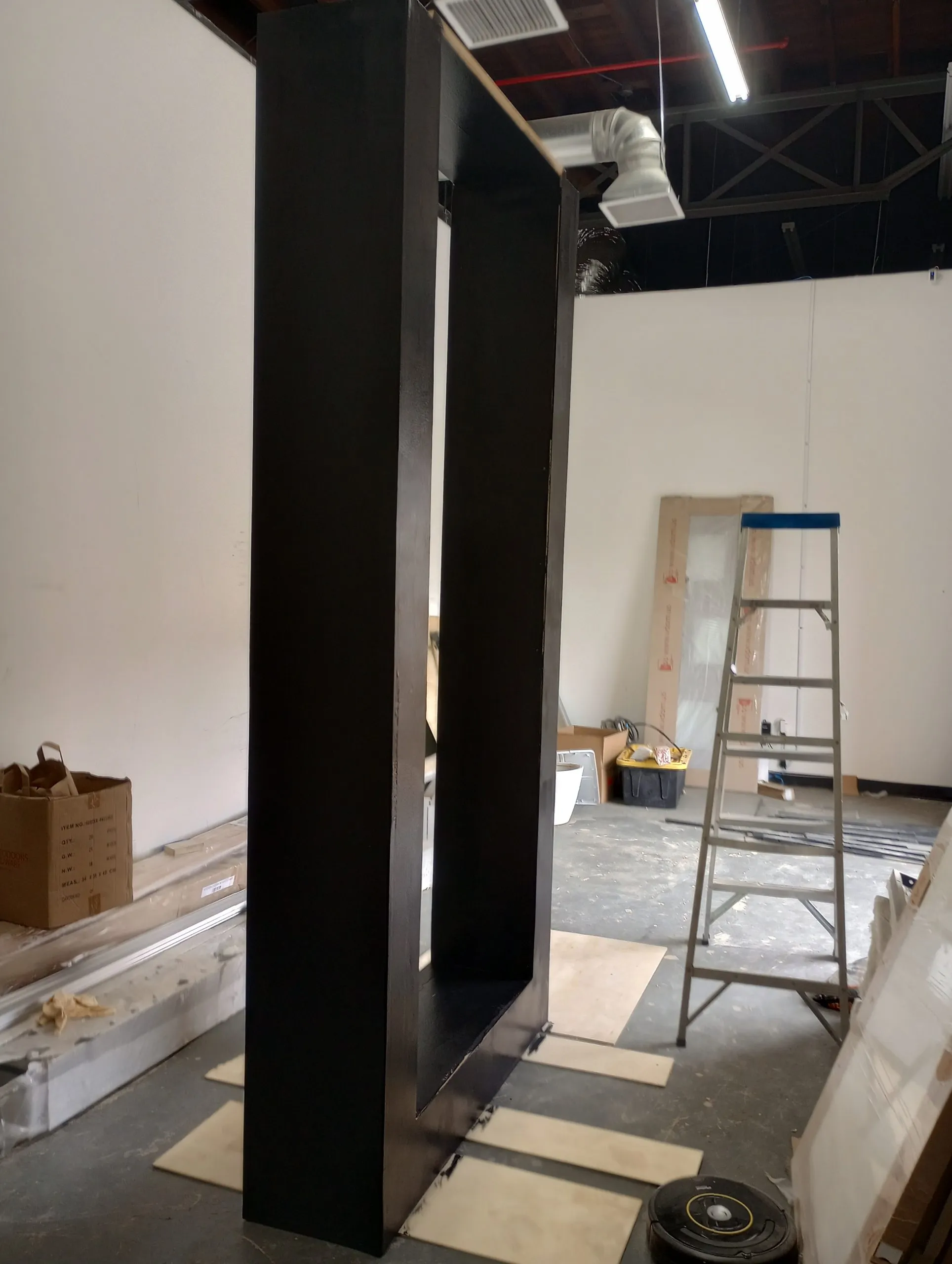Black framed partition and ladder in a commercial space