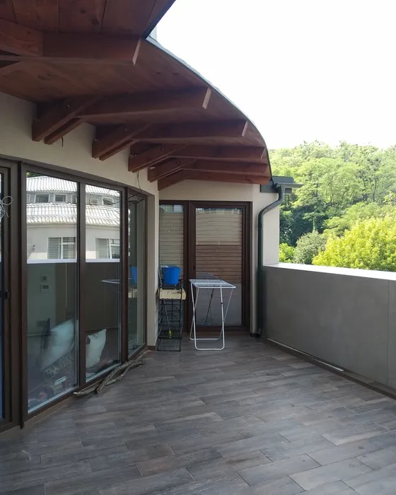 Covered terrace with new tile floor and glass doors